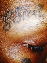 Close-up Of Tattoo On Forehead
