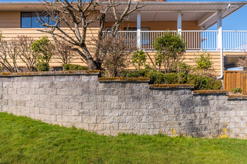 Wall Mural - Fence built from trees and stones. Outdoor landscape. Security and privacy concept. Vancouver. Canada.