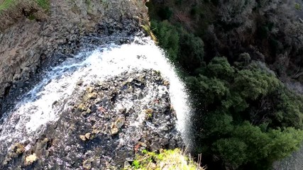 Wall Mural - Panning over a waterfall looking down