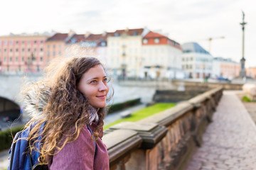 Warsaw, Poland old town historic Castle square street in capital city with young tourist happy woman and old town blurry background