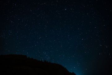 Wall Mural - night landscape with starry sky. astrology, space