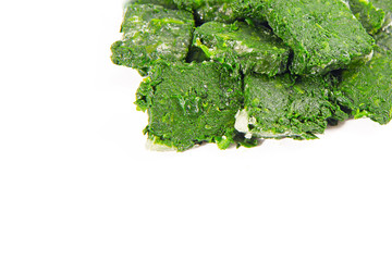 Wall Mural - a block of frozen spinach isolated on a white background