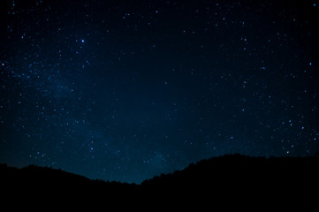 Night photograph depicting stars. Night cosmic sky. Astrophotography.