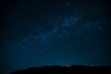 Night photograph depicting stars. Night cosmic sky. Astrophotography.