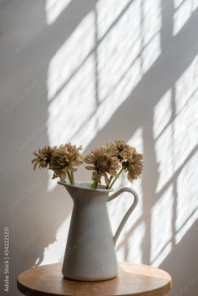 Close-up Of Flowers In Vase On Wooden Table Against Wall - obrazy, fototapety, plakaty 
