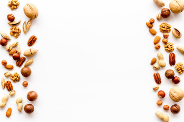 Wall Mural - Nuts background - with almond, macadamia, walnut - on white table top-down frame copy space