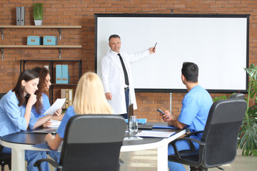 Sticker - Male lecturer teaching medical students in university