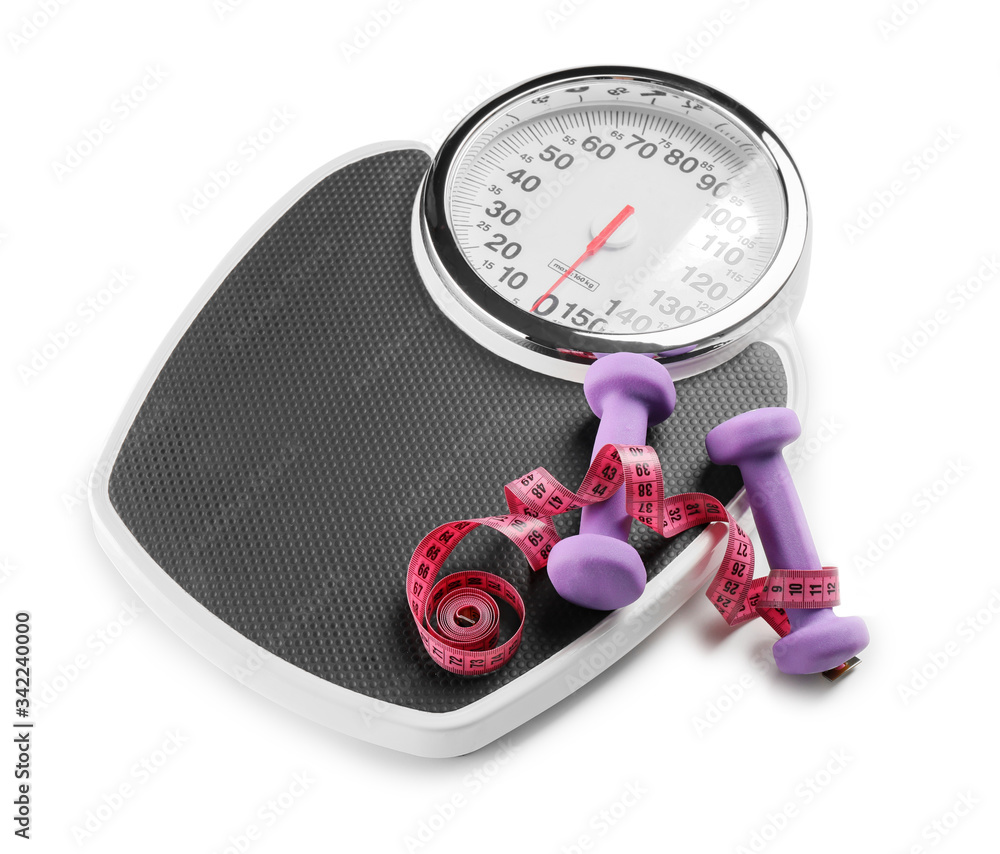 Weight scales with measuring tape and dumbbells on white background. Slimming concept