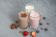 Assorted protein cocktails with fresh fruits, berries and chocolate. Protein shake. Sports nutrition and healthy lifestyle concept.