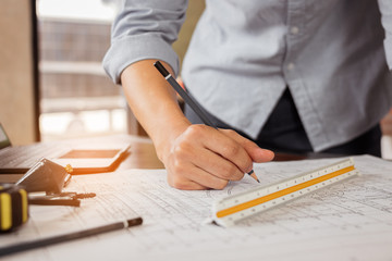 Engineer or architect hand sketch the drawing construction building on the desk. Civil engineering, Architect concept.