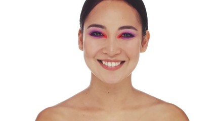 Poster - A surprised young half-naked woman with bright fashion eye makeup is smiling to the camera isolated over white background