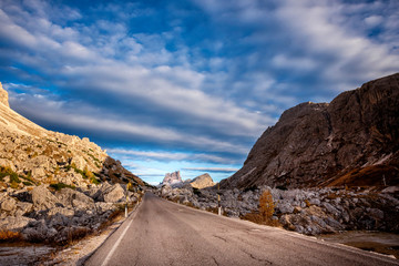 Pass Falzarego in autumn. Picturesque valley among the Dolomites. The majestic Alps. Trentino Alto Adige, Italy