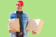 © Angelov - Delivery man in mask and gloves bring fresh food to customer's home. Stay home. Online shopping concept. green background