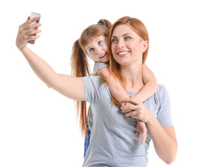 Sticker - Woman and her little daughter taking selfie on white background