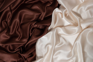 smooth elegant beige and brown background of silk fabric lined with waves