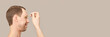 © elenavolf - Man skin care routine. Oil pipette near male face. Haircare facial treatment. Applying healthy cosmetics. Anti wrinkles procedure. Grey background