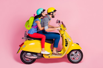 Canvas Print - Profile side view of his he her she nice attractive cheerful cheery couple driving moped pastime having fun vacation adventure isolated over pink pastel color background