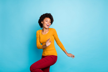 Poster - Portrait of wild crazy millennial afro american clubber girl dance in discotheque feel enjoy rejoice wear red pants trousers isolated over blue color background