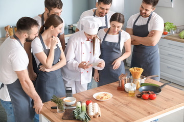 Wall Mural - Female chef and group of young people during cooking classes