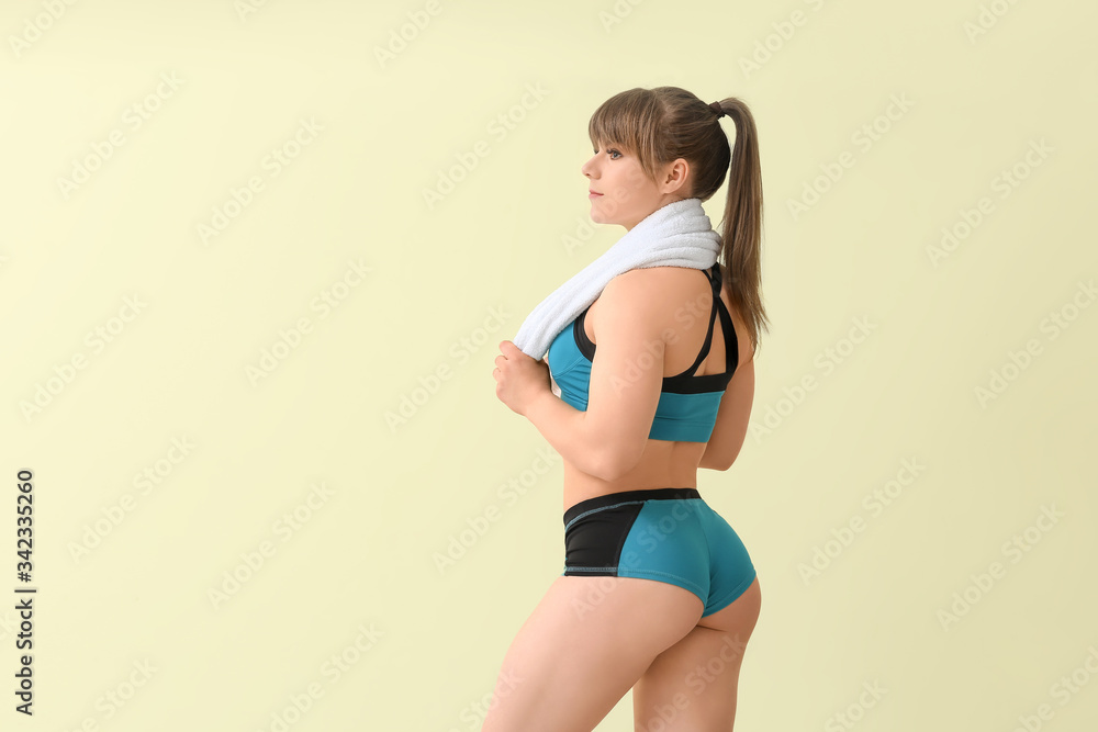 Sporty muscular woman on color background