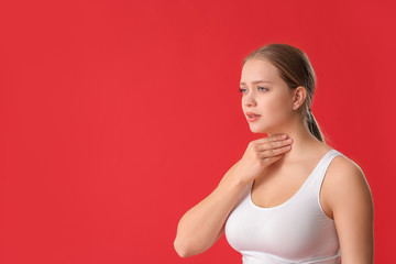 Poster - Young woman with thyroid gland problem on color background