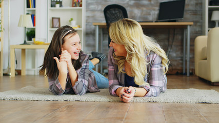 Wall Mural - Little girl with braces lying on the floor