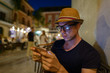 © Ranta Images - Young handsome tourist man using mobile phone outdoors