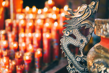 Close-up Of Illuminated Candles And Metallic Sculpture