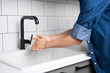 Man Washing Hands in the Kitchen with Warm Running Water