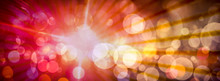 Abstract Light Circular Bokeh Background In Red And Yellow Colors And Light Rays.