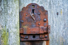 Old Rusty Lock With A Key On Wooden Door