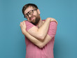 © koldunova - If you are single, hug yourself. Funny, cute bearded man in glasses cuddling himself and dreams with eyes closed.