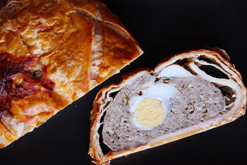 Wall Mural - Photography of an Easter pie an slice on slate for food illustrations