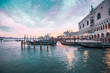 Colorful sunset in Venice, gondolas and reflections in the water