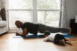 © Gerald Carter/Creative Flame - Father and son working out at home with baby during quarantine