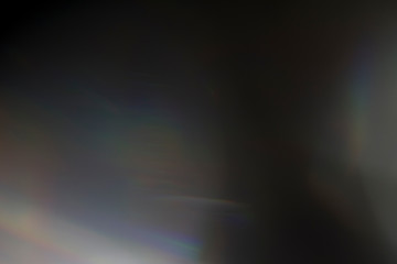 Wall Mural - sun reflection over a piece of crystal for a colorful lens flare on black background