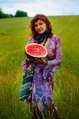 woman with melon hands in beautiful ornamental dress.