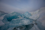 Fototapeta Tęcza - Beautiful clear ice of Lake Baikal on a sunny day