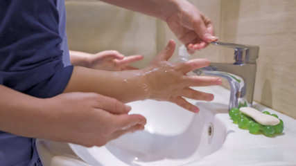  Mother With Son Washing Hands Together