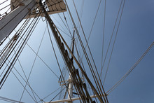 Labyrinth Of Tall Ship Rigging Lines And Masts Seen From Below, Against A Deep Blue Sky, Horizontal Aspect