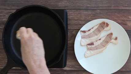 Wall Mural - Adding Raw Bacon to a Cast Iron Skillet