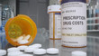 © Stock Footage, Inc. - Prescription drug cost bottle with pills out in medical lab