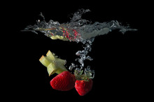 Close-up Of Strawberries In Water Against Black Background