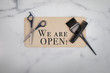 Hair salon we are open sign no people flat lay background with scissors black small comb hairstylist color applicator opening message