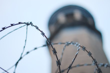 Low Angle View Of Razor Wire Against Lighthouse
