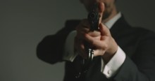 Secret Service Man In Business Suit Points Gun Towards Camera - Close Up