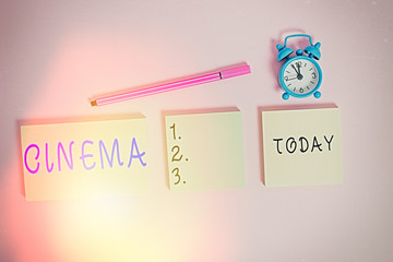 Word writing text Cinema. Business photo showcasing theater where movies are shown for public entertainment Movie theater Three multicolor blank notepads alarm clock marker colored background