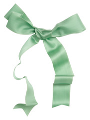 Wall Mural - Green ribbon curl isolated on white background. Bright green ribbon bow and curl isolated on white background. Textile accessories for sewing and gift scrapbooking decorations. Atlas or silk ribbon
