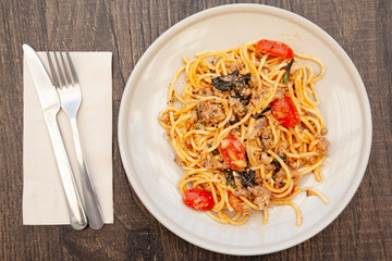 Wall Mural - Spaghetti bolognese with tomato, cheese and basil on a plate