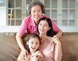 © Tom Wang - happy grandmother and daughter with granddaughter at home